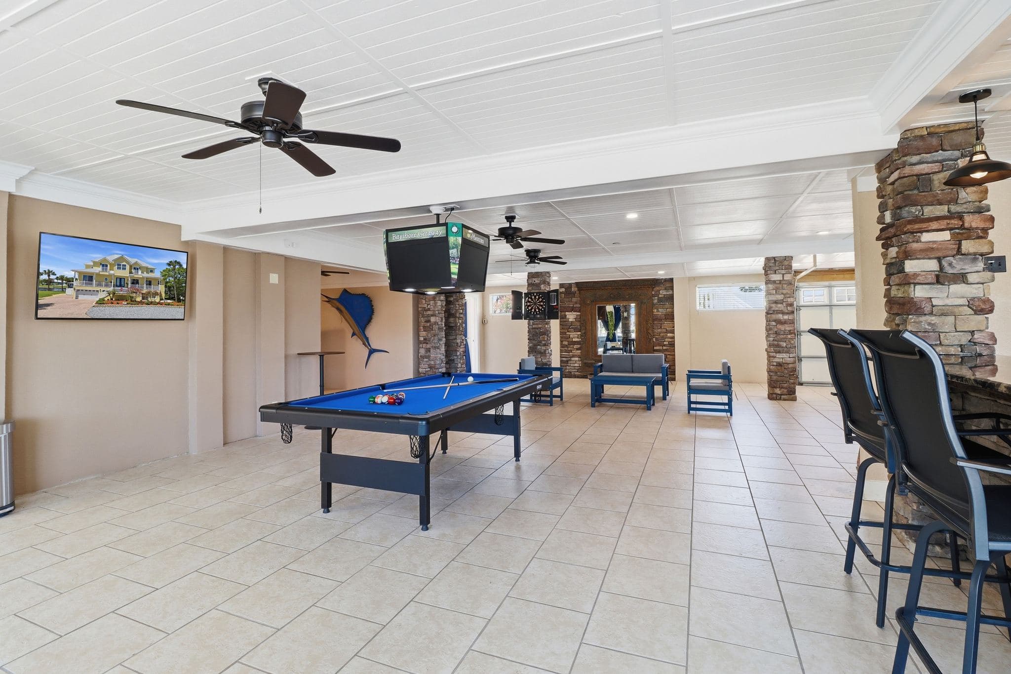 Game room at Bayshore Getaway with full-size pool table, the Crystal River vacation rental's first-floor entertainment space